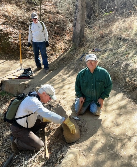 Pat, Bruce and Mike get the rock set properly.